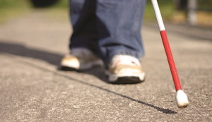 photo of a cane being used by a visually-impaired person