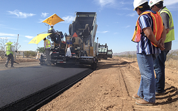 a work crew laying a new road