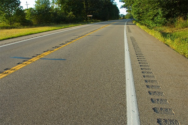 photograph of a road with non-freeway shoulder and centerline rumble strip installation