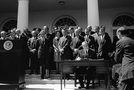 President Lyndon B. Johnson signing the National Traffic and Motor Vehicle Safety Act of 1966 and the Highway Safety Act of 1966
