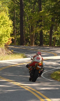 a motorcyclist riding on a curving road
